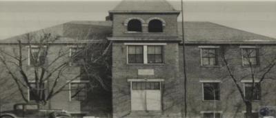 Old schoolhouse with a truck in front